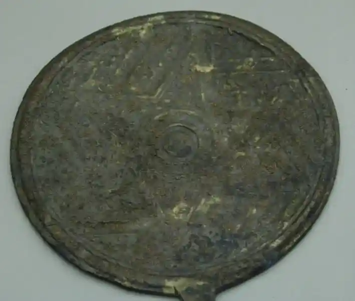 Bronze badge with a hexagon, six-pointed sun symbol